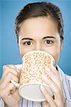 Close-up of a young woman drinking coffee from a mug
