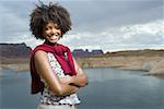 Portrait of a young woman standing on a lakeside