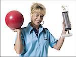 Female bowler holding trophy