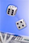 Close-up of a pair of dice above US currency