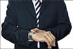 Mid section view of a businessman looking at his wristwatch