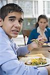 Portrait of a teenage boy sitting at a dining table