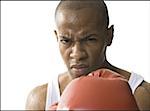 Portrait of a young man wearing boxing gloves