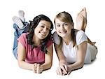 Portrait of two girls lying on the floor