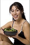 Portrait of a woman holding a bowl of salad