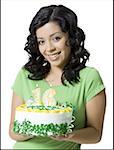 Close-up of a teenage girl holding a birthday cake