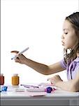 Girl sitting at table doing crafts