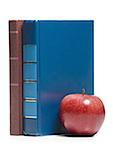 Close-up of an apple with two books