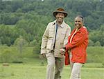 Portrait of a senior man and a senior woman walking in a field