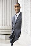 Portrait of a male lawyer standing in front of a courthouse and smiling