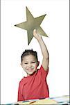 Portrait of a boy holding a star