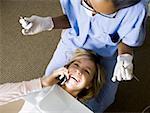 Girl with dental hygienist talking on cell phone