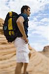 Profile of a young man carrying a backpack