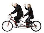 Older couple riding a tandem bicycle