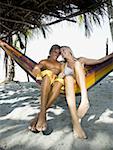 Young couple sitting in a hammock