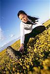 Young woman stretching on a field