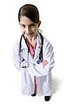 Young girl dressed as doctor with white coat and stethoscope