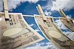 Close-up of Japanese currency pegged to a clothesline