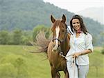 Portrait of a woman standing with a horse