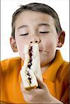 Close-up of a boy eating a sandwich