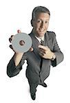 Portrait of a businessman holding and pointing to a compact disc