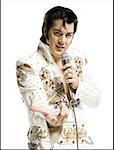 Portrait of an Elvis impersonator singing into a microphone