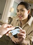 Close-up of a businesswoman giving a key to a businessman