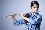 Portrait of a teenage girl playing the flute