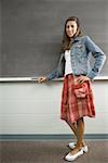 Female student leaning against chalkboard