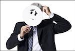 Businessman holding a confused face mask