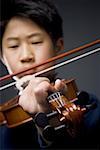 Close-up of a boy playing the violin