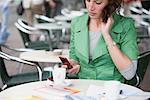 Woman Using Cellular Phone at Cafe