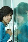 Teen boy opening sliding glass door