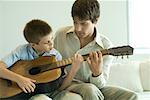 Father and son playing guitar together