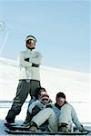 Young snowboarders on ski slope, full length portrait