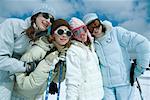 Young skiers standing on ski slope, portrait