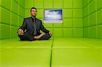 Businessman with Television in Green Padded Room