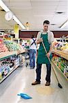 Sales Associate in Grocery Store Cleaning Aisle