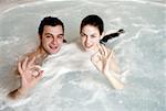 One man with two woman  in jacuzzi at a spa