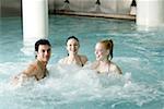 Young people swimming in spa pool