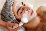 Man having a facial treatment in a spa