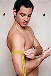 Man measuring his arm muscle