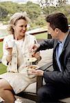Mature couple having beverages on hotel terrace