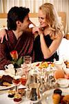 Couple having room service breakfast in hotel room