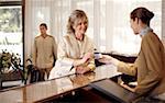 Woman checking in at the hotel reception desk