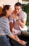 A young couple eating breakfast