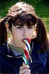 Teenage girl  licking a lollipop