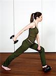 Young woman exercising with weights