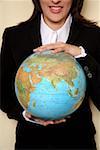 A woman  holding a globe