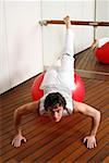 Young man performing a pilates exercise